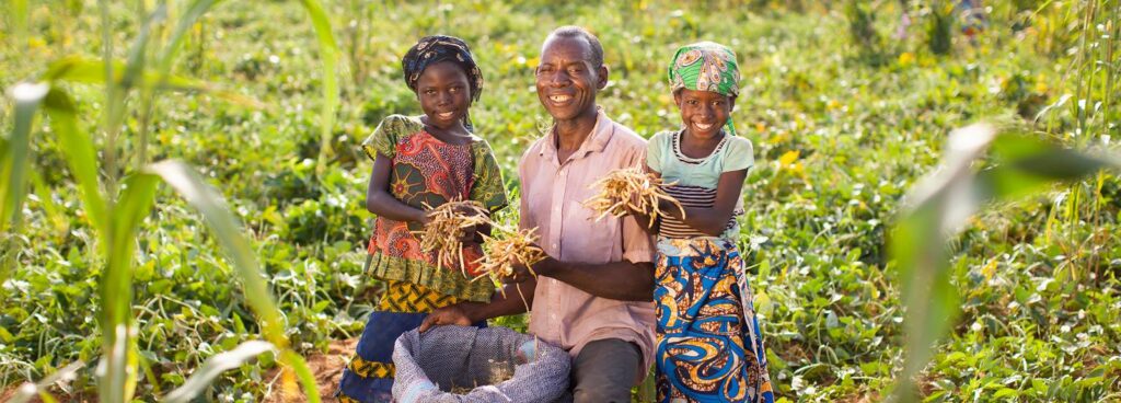 Man, woman and child in a farming field