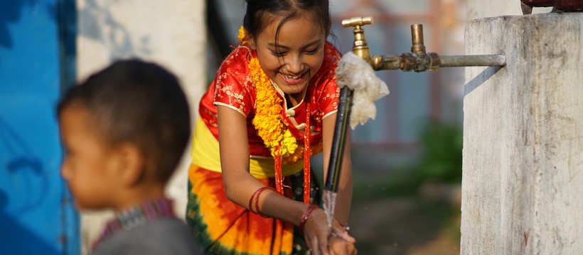 Young girl washing her hands