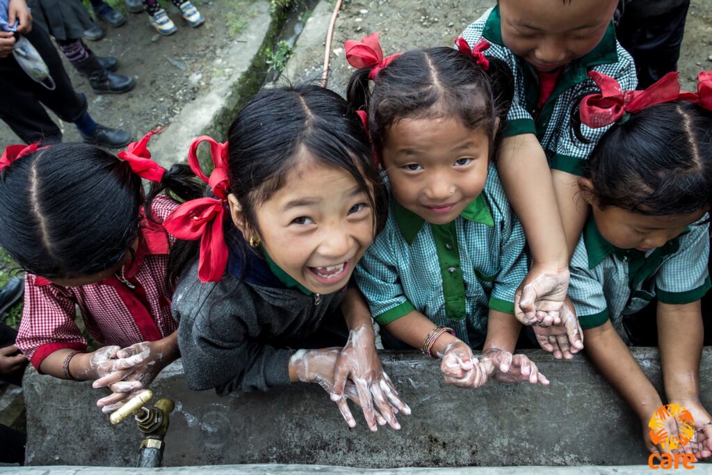 Children washing their hands.