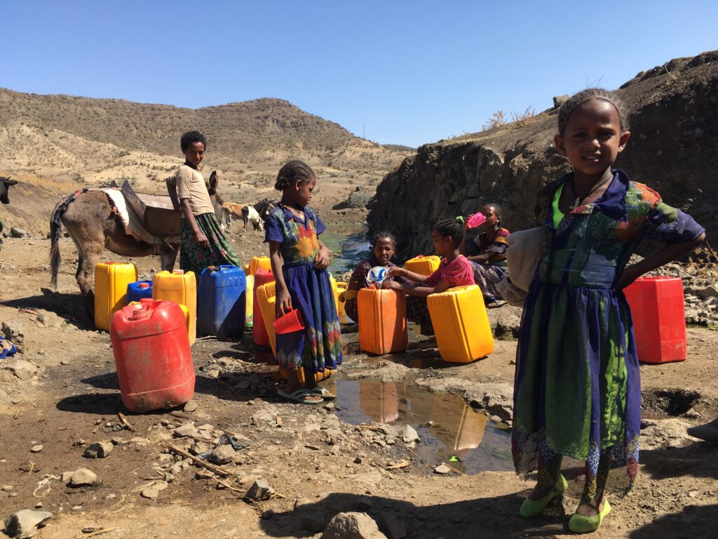 Children collecting water from a spring in Ethiopia