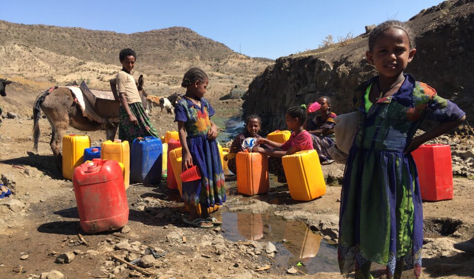 Children collecting water from a spring in Ethiopia