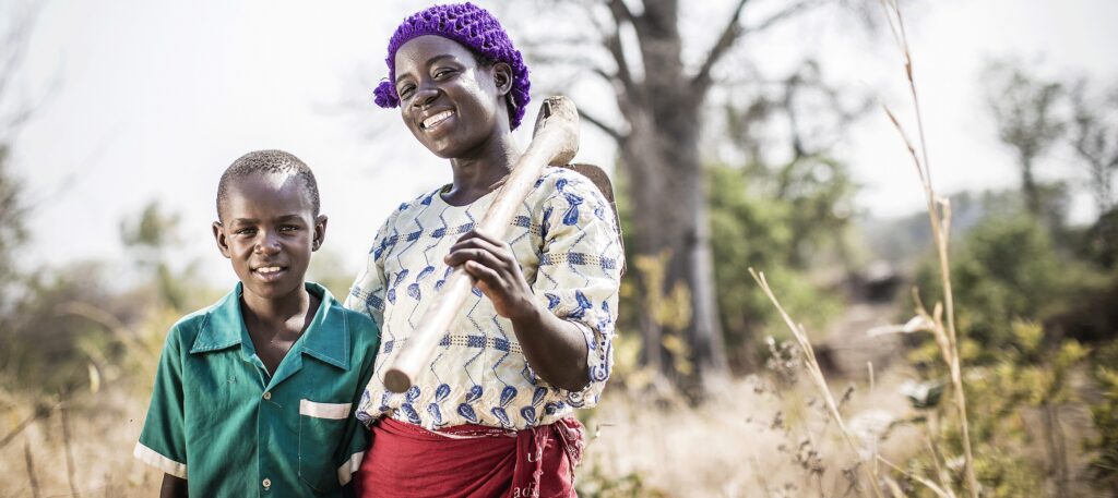 Boy and Girl standing in a field in Africa